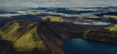 Aerial view of a volcanic lake surrounded by dark volcanic rock and green vegetation, with a vast...