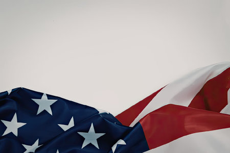 A close-up view of the American flag waving gently, showcasing its iconic red and white stripes and...