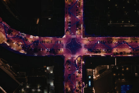 City highway intersection at night with vibrant purple and blue lights