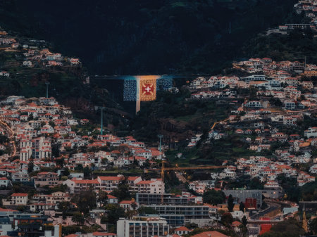 Cityscape with vibrant flag display in mountainous terrain