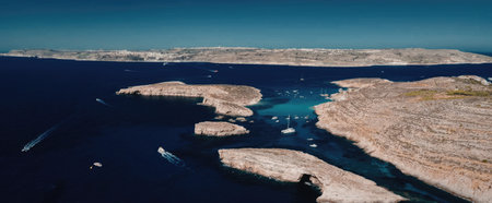 Aerial view of coastal town with rocky shoreline and clear blue water