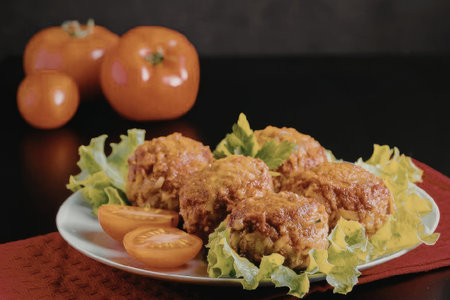 Delicious meatballs served with fresh tomatoes and lettuce