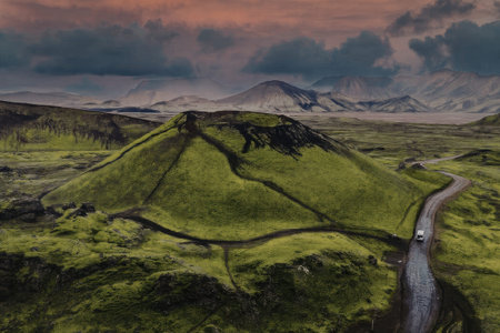 Driving through the rolling green hills under a dramatic sky
