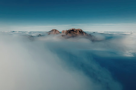 Majestic mountain peaks rising above the clouds