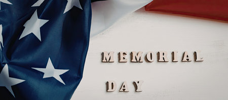 A patriotic image featuring the American flag and the words 'Memorial Day' on a white background