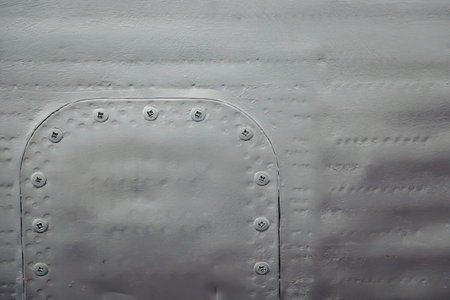 Metal surface with riveted patch