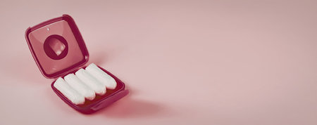 A pink case with white tablets on a pink background