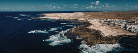 Scenic aerial view of coastal town with sandy beach and rocky shoreline