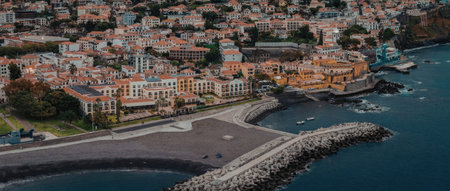 Scenic aerial view of coastal town with harbour and buildings