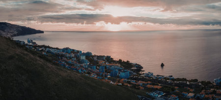 Serene coastal town at sunset with calm waters and peaceful atmosphere