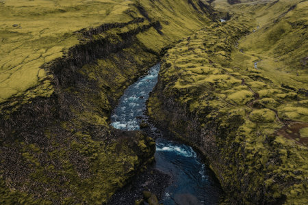 Serene river flowing through lush green valley