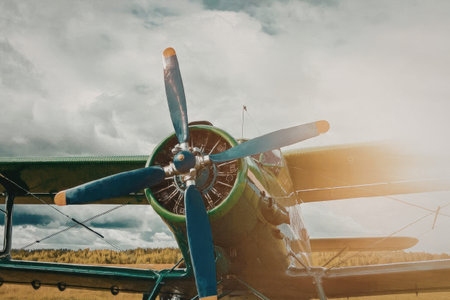 Close-up of a vintage airplane propeller with a green outline around the engine, set against a...
