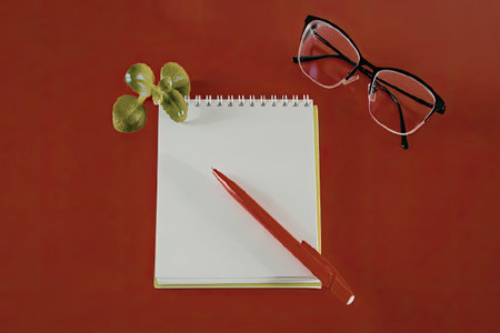 Writing on red background with glasses and penの写真素材