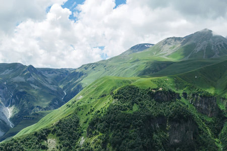 A serene mountain landscape featuring lush green hills and a cloudy sky.