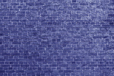 A close-up of a blue brick wall with white mortar between the bricks.の写真素材