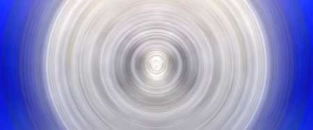 An abstract image featuring a white light effect with concentric circles on a blue background.