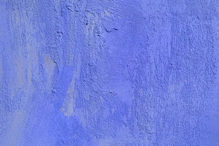 A close-up view of a blue painted wall with a textured surfaceの写真素材