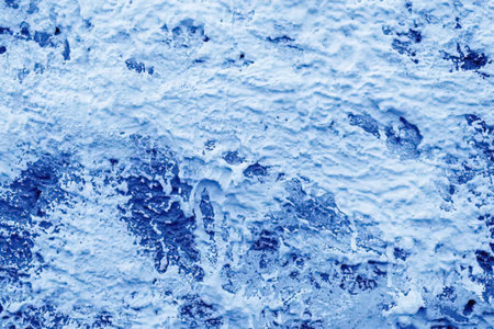 A close-up view of blue water with a textured surface, showcasing its natural patterns and...
