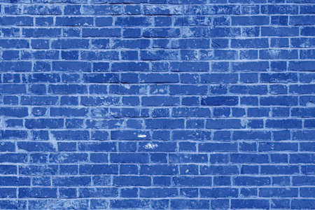A blue brick wall with white spots and a white background