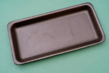 A brown rectangular baking tray on a green backgroundの写真素材