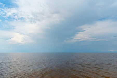 a vast body of water under a cloudy skyの写真素材