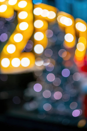 A close-up view of a marquee sign with bright lights, blurred background with colorful bokeh effectの写真素材