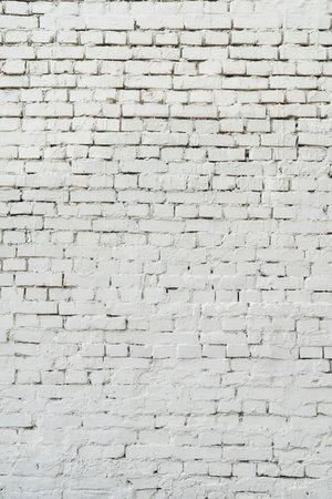 A close-up view of a white painted brick wall with visible mortar lines