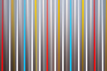 A vibrant and colorful pattern of vertical stripes in various colors including red, yellow, blue,...