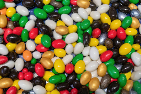 A vibrant and colorful mix of jelly beans fills the entire frame of this image, showcasing a variety...