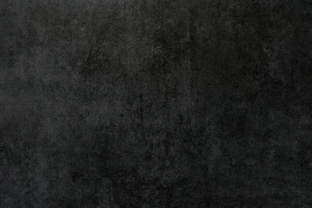 A dark background with a textured surfaceの写真素材