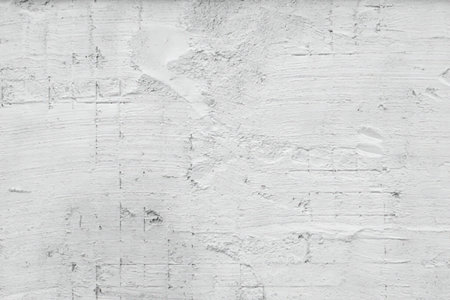 A close-up view of a textured surface, possibly a wall or concrete with visible marks and scratches.
