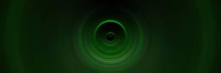A green light effect on a dark background, resembling a lens flare or a circular glow.の写真素材