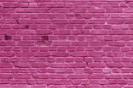 A close-up view of a pink brick wall with a white backgroundの写真素材
