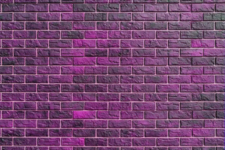 A close-up of a purple brick wall with a white background, showcasing the vibrant color and texture of the bricks.の写真素材