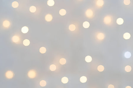 A blurry image of numerous small, glowing lights on a gray background.