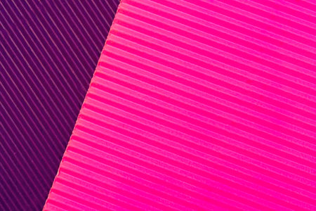A visually striking image featuring a diagonal split of purple and pink hues with striped patterns.