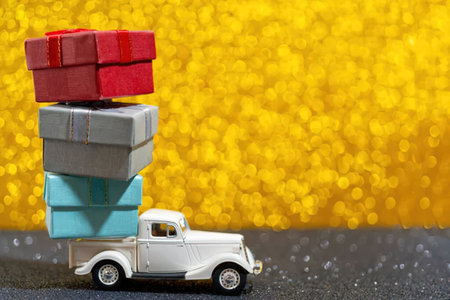 A white vintage truck carries a stack of colorful blocks on its bed.の写真素材