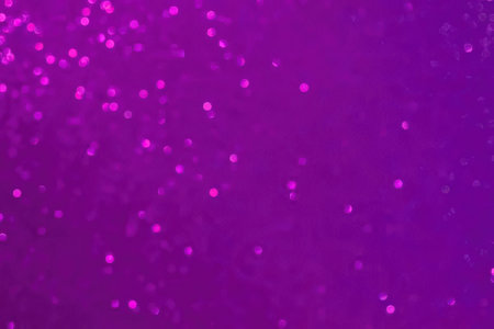A purple background with scattered pink specks, creating a visually striking and vibrant image.の写真素材