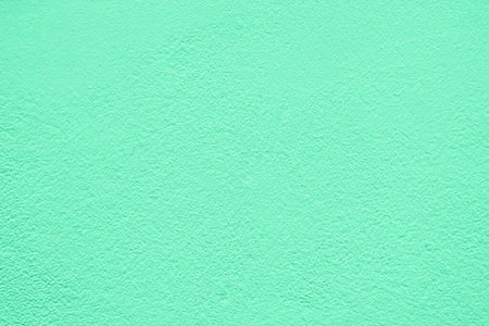 Mint green textured surface with a rough uneven finish is ideal for design and creative projects...