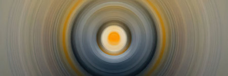 Vibrant abstract spiral design features blurred colorful rings in shades of orange, yellow, and blue...
