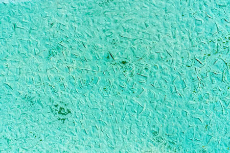 Turquoise textured surface with visible imperfections and subtle color variations creating a unique...