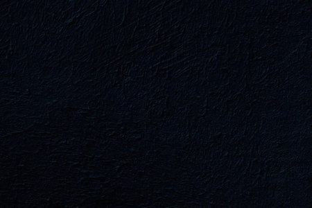 Dark blue textured surface with subtle highlights and deep shadows creating a luxurious and...