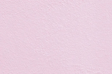 Soft pastel pink textured background with a subtle grainy effect creating a calming and serene...