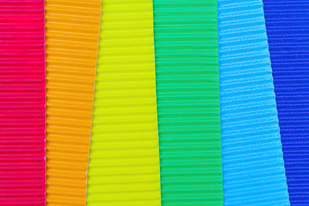 Colorful ribbons in red, orange, yellow, green, and blue hues arranged in a rainbow pattern perfect...