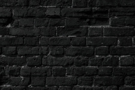 Dark grungy brick wall texture with rough surface and blackened bricks perfect for background or...