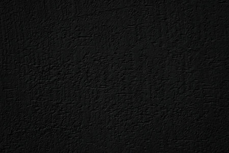 Dark textured black surface with a rough and uneven pattern visible in dim lighting conditions...
