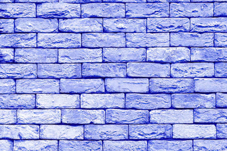 Blue brick wall with textured stone pattern and uniform design creates a visually appealing...