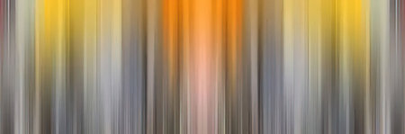 Blurred vertical lines create a vibrant abstract background in shades of yellow, orange, and gray,...