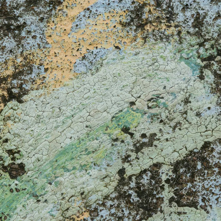 Cracked paint reveals a textured surface with earthy tones and abstract patterns creating a grungy,...