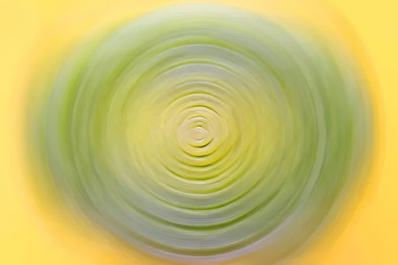 Fresh green leek with visible layered rings is centered on a bright yellow background, showcasing...